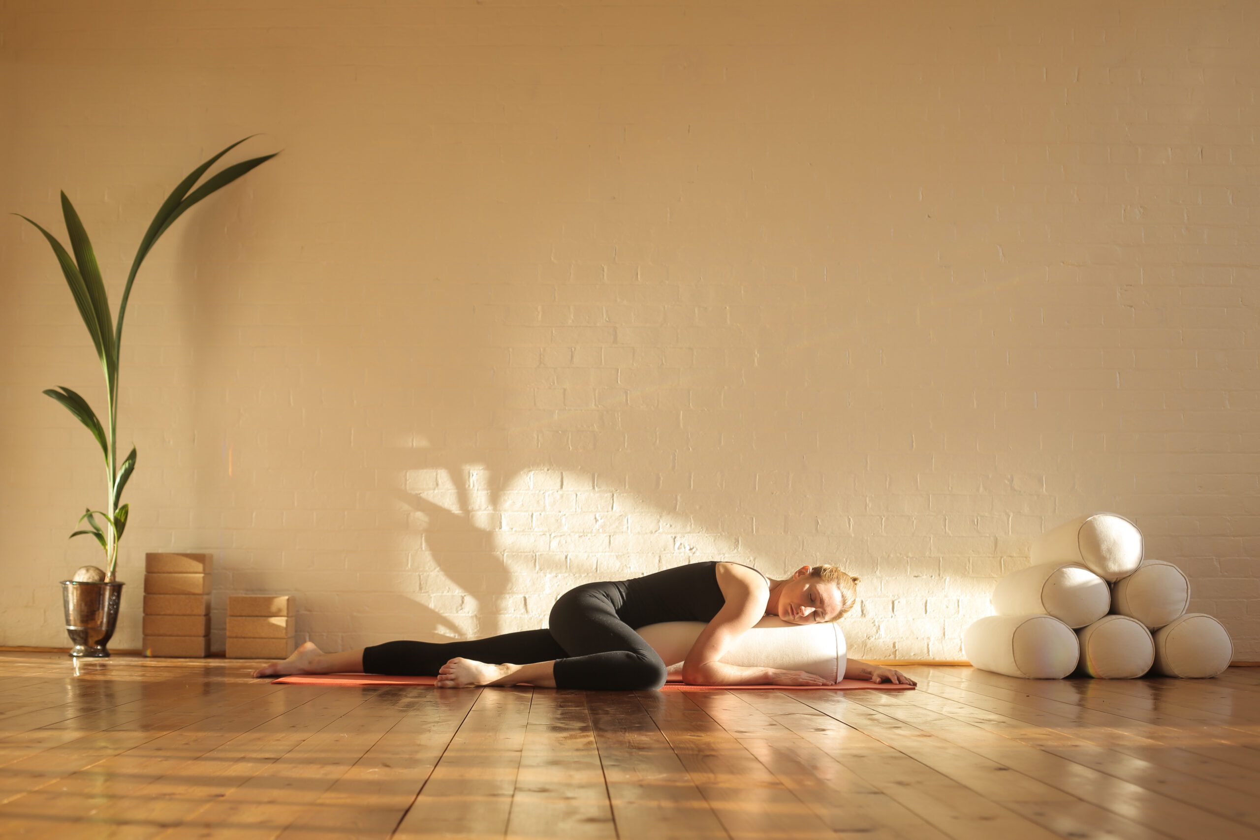 Woman in relaxation posture with a bolster