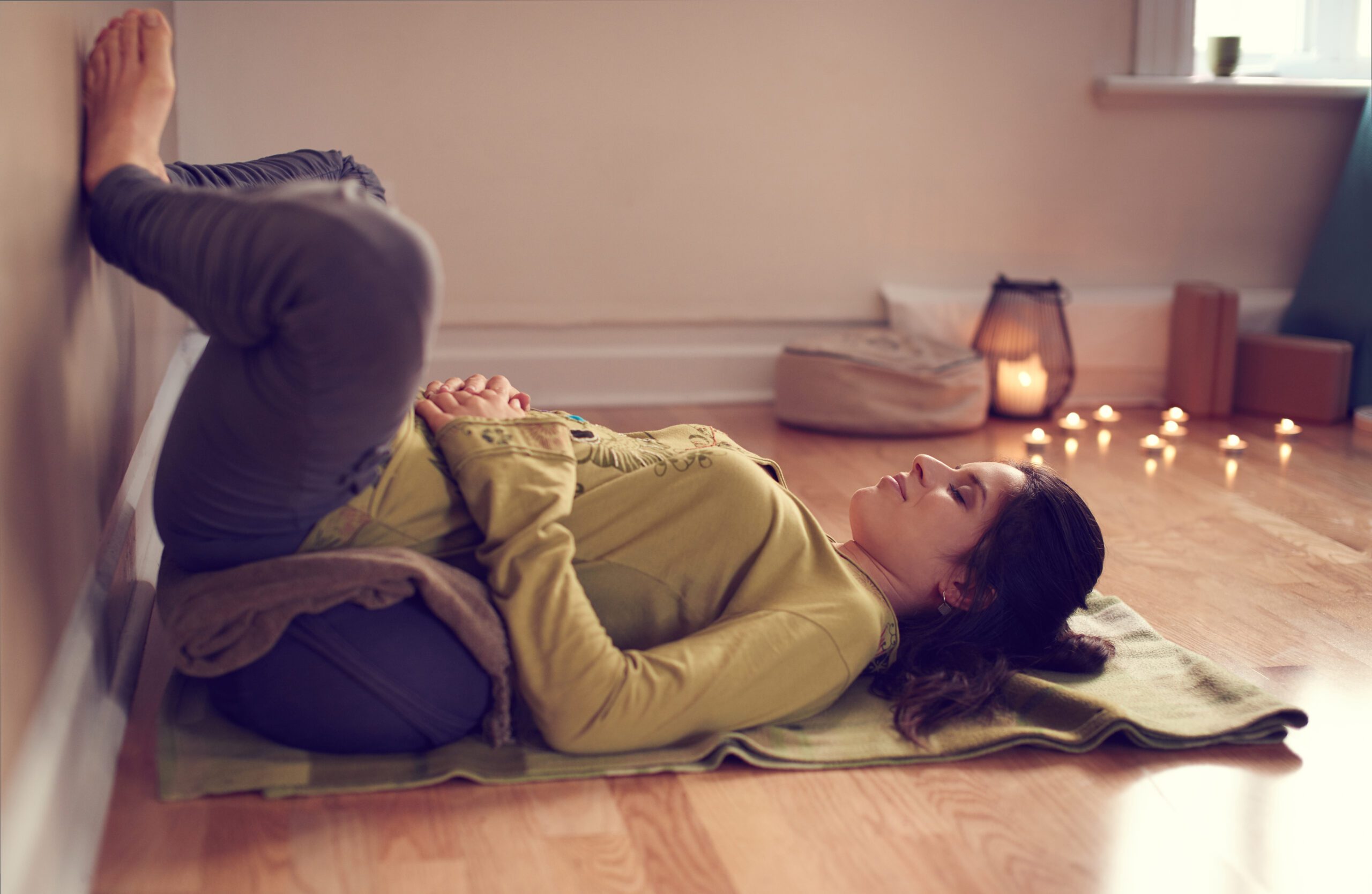 Yoga practitioner using a bolster in the relaxation position